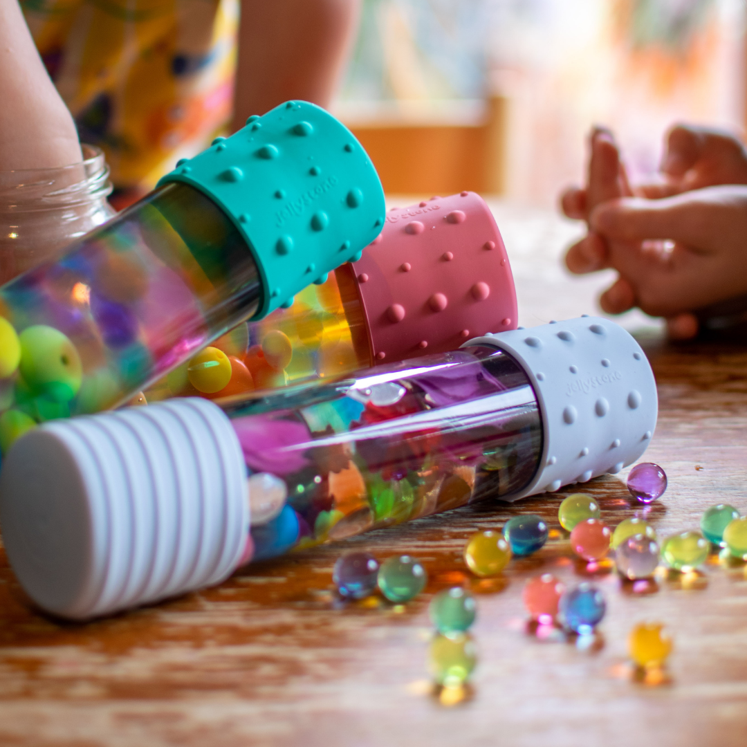 Calm Down Bottles on table with water marbles