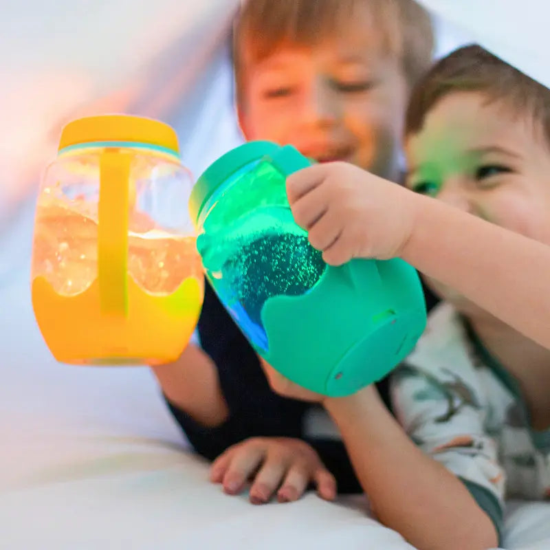 Boys playing with light up sensory jar