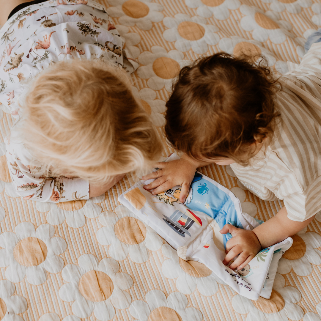 Kids playing with baby soft book
