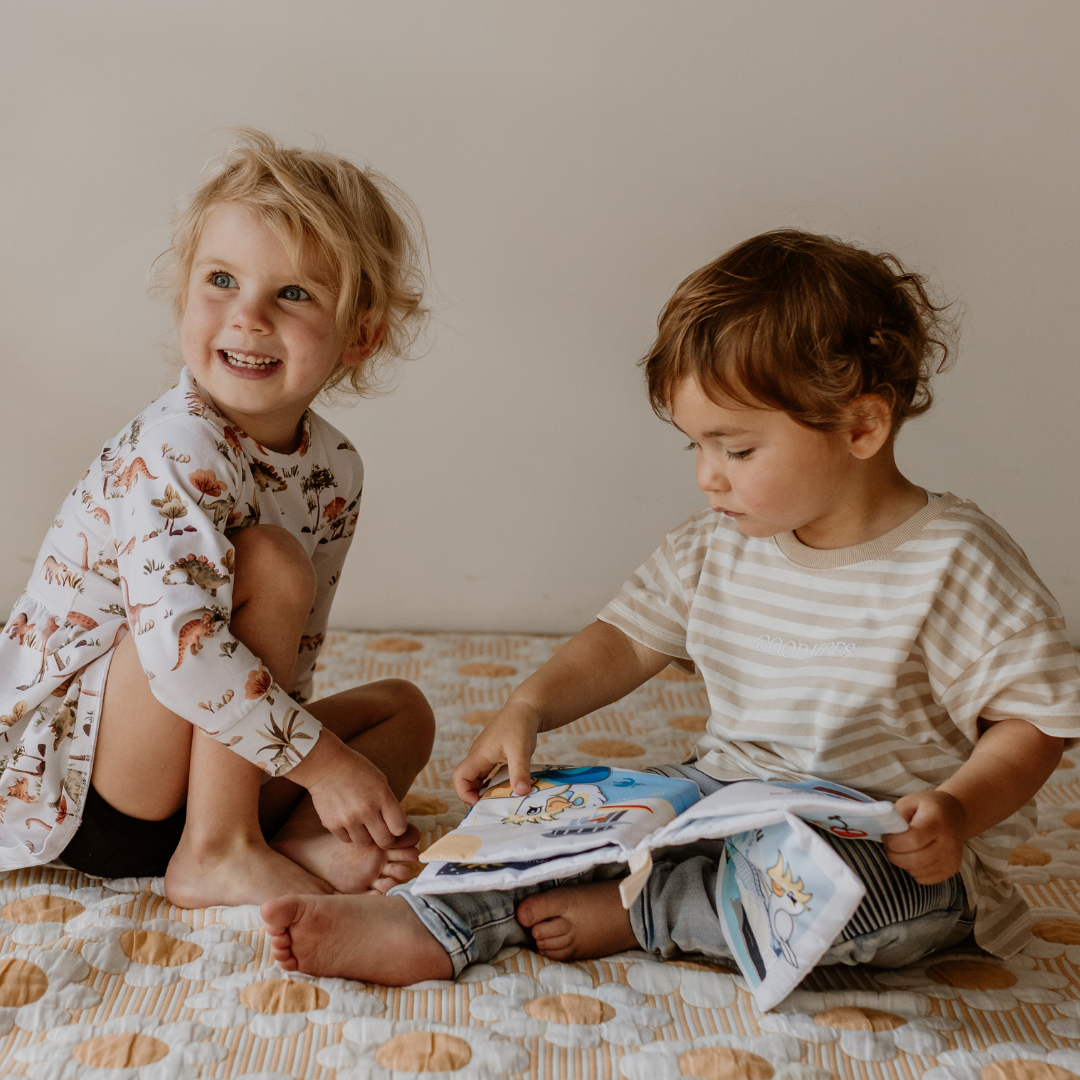 Kids playing with baby soft book