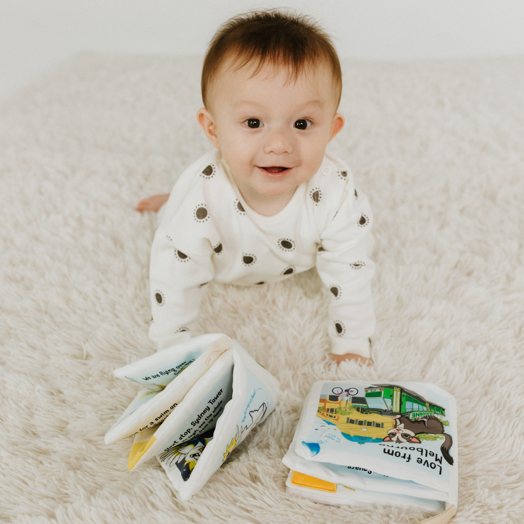 Baby playing with baby soft book