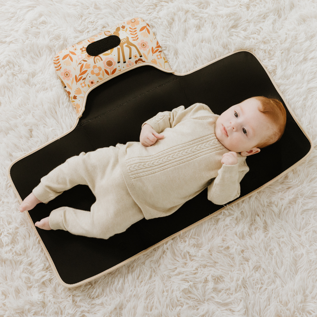 Baby lying on change mat 