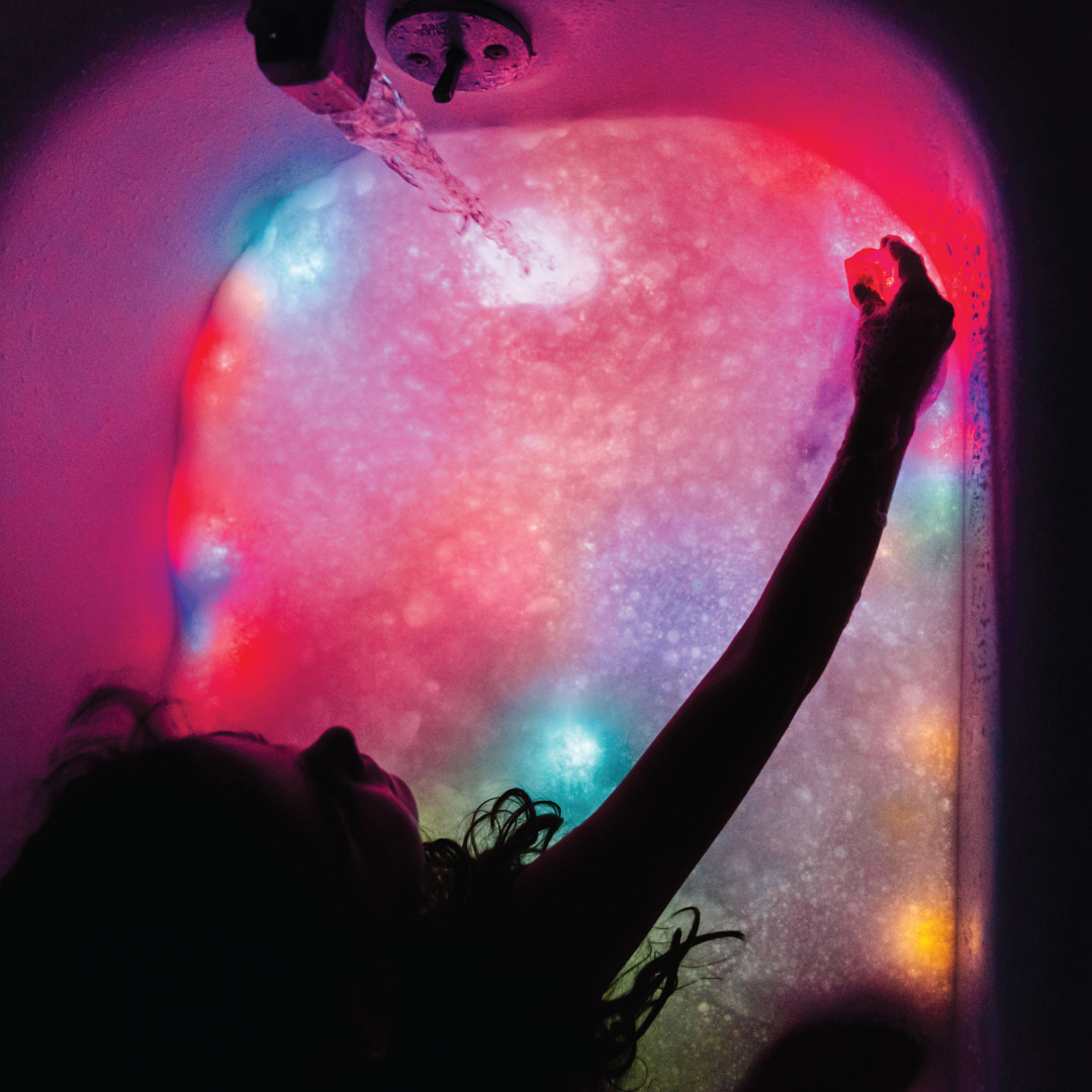 Girls playing with light up cubes in the bath