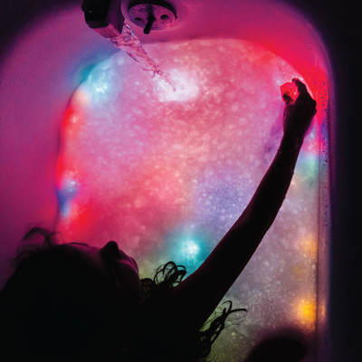 Girl playing with light up cubes in the bath