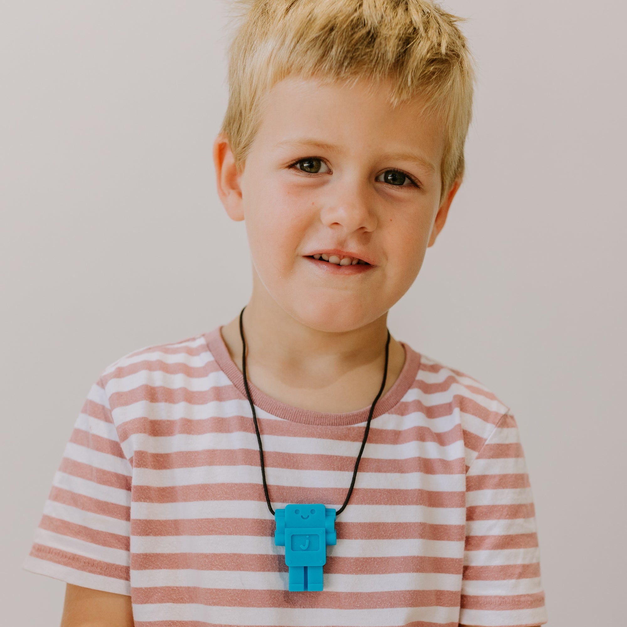 Boy wearing robot silicone pendant