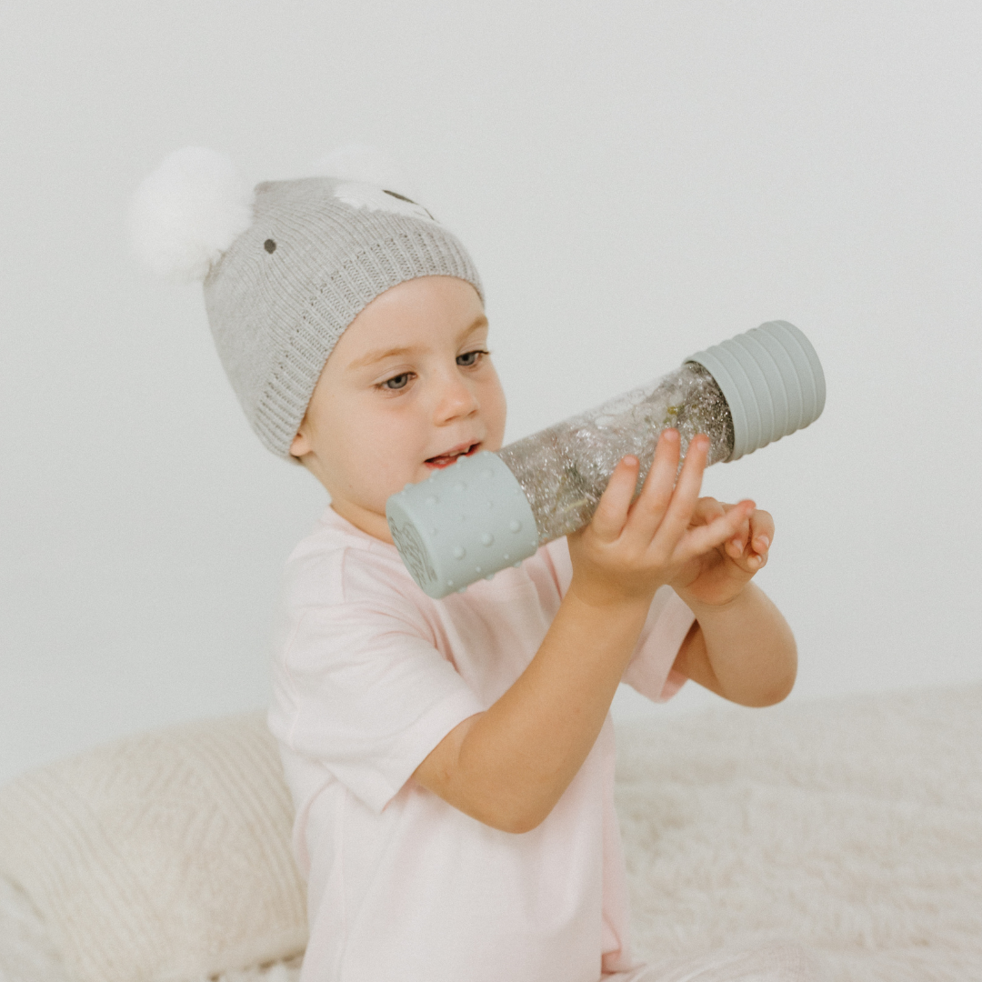 Girl playing with sensory bottle