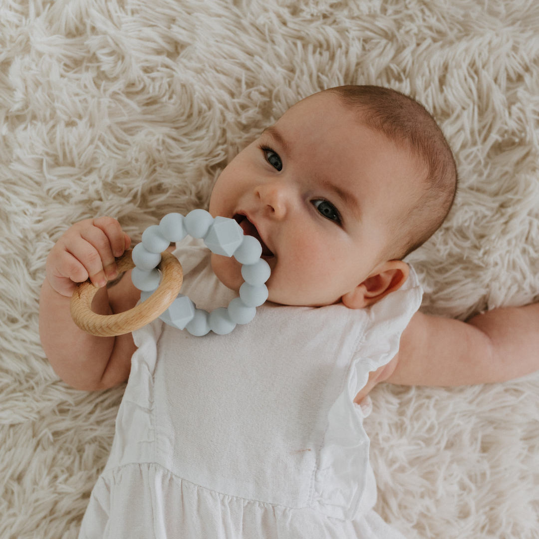 Baby chewing may gibbs blue moon teether ring