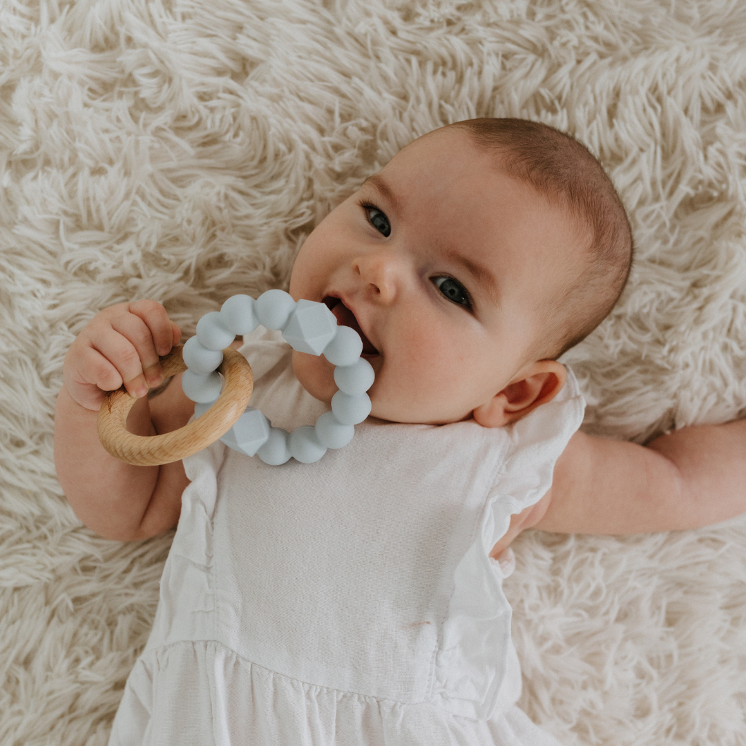 Baby chewing on May Gibbs moon teether