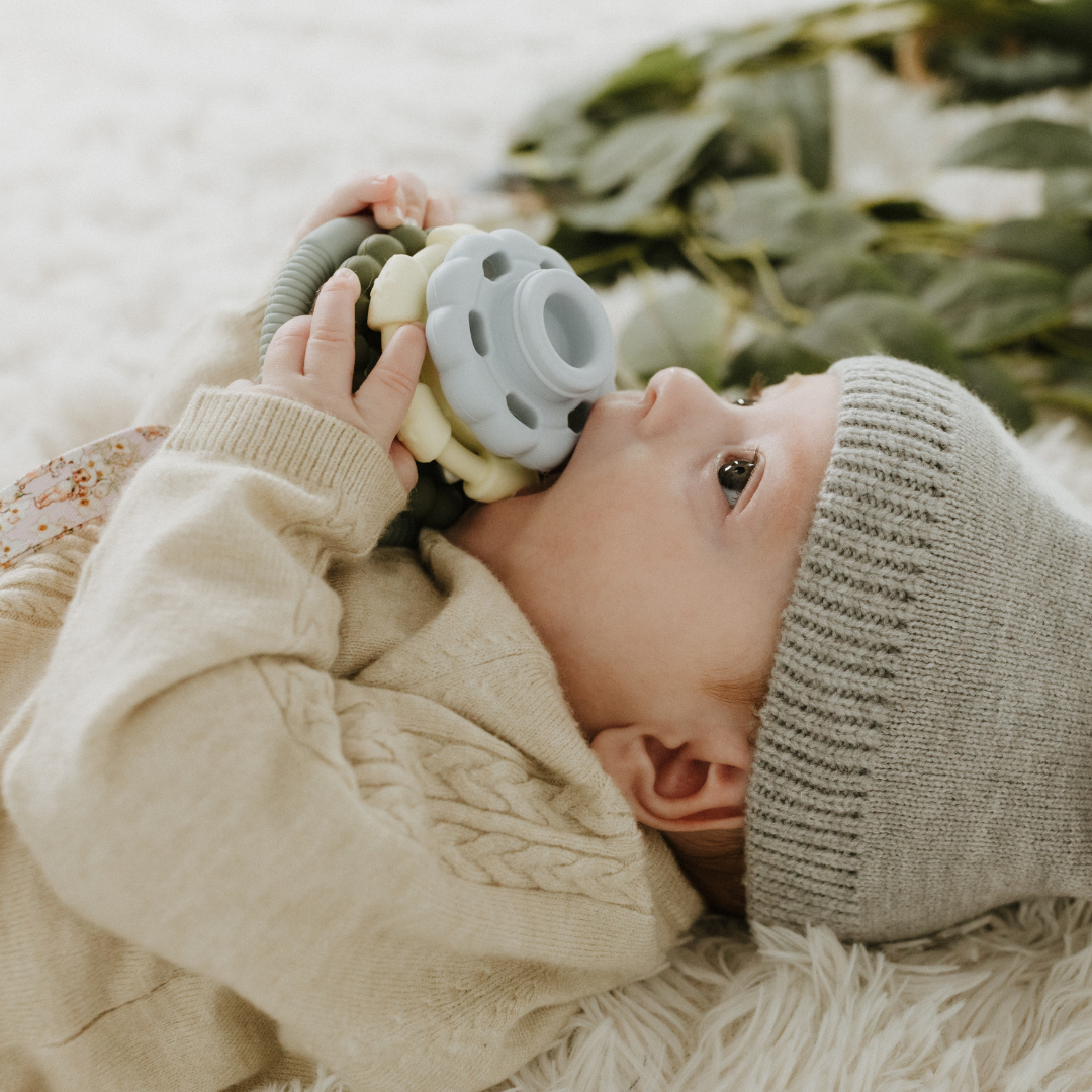 Baby chewing on May Gibbs stacker
