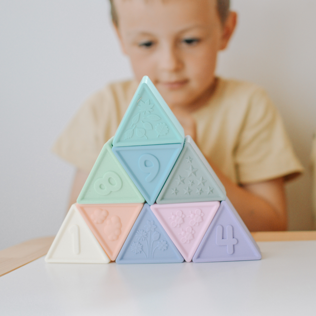 Boy playing with pastel silicone triangle blocks