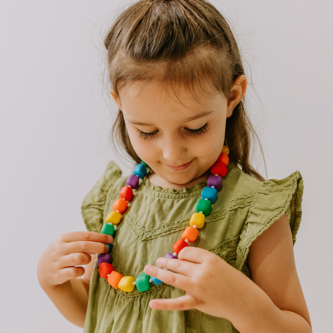 Girl wearing rainbow silicone necklace