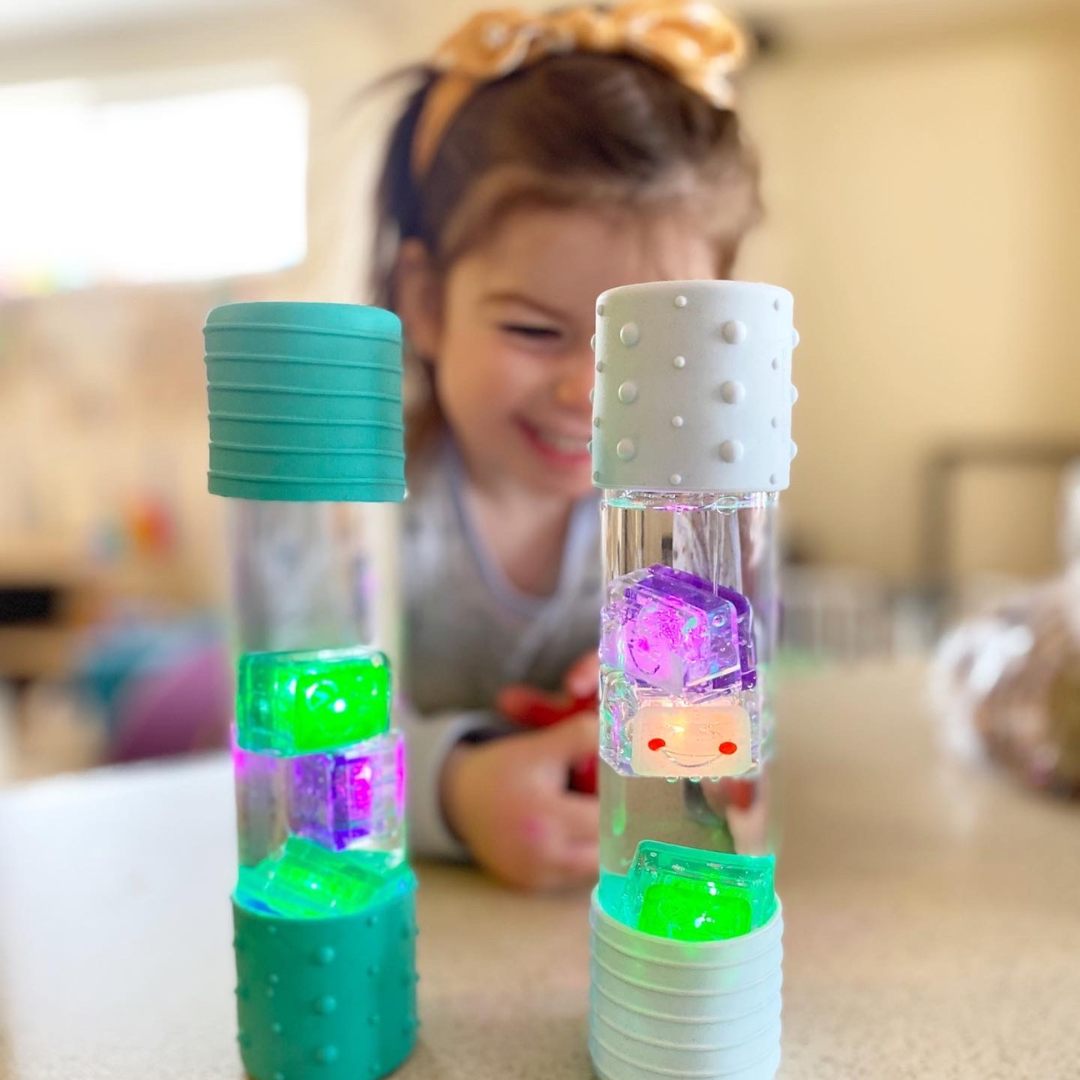 Girl playing with glo pals cubes in a calm down bottle