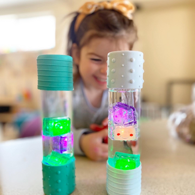 Girl playing with glo pals cubes in a calm down bottle