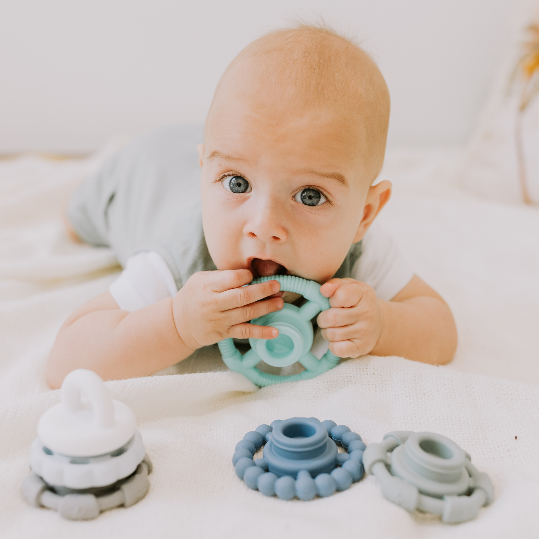 Baby boy chewing on the silicone stacker
