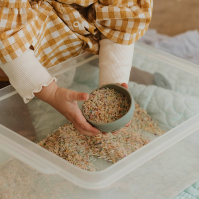 Kids playing with colourful rice
