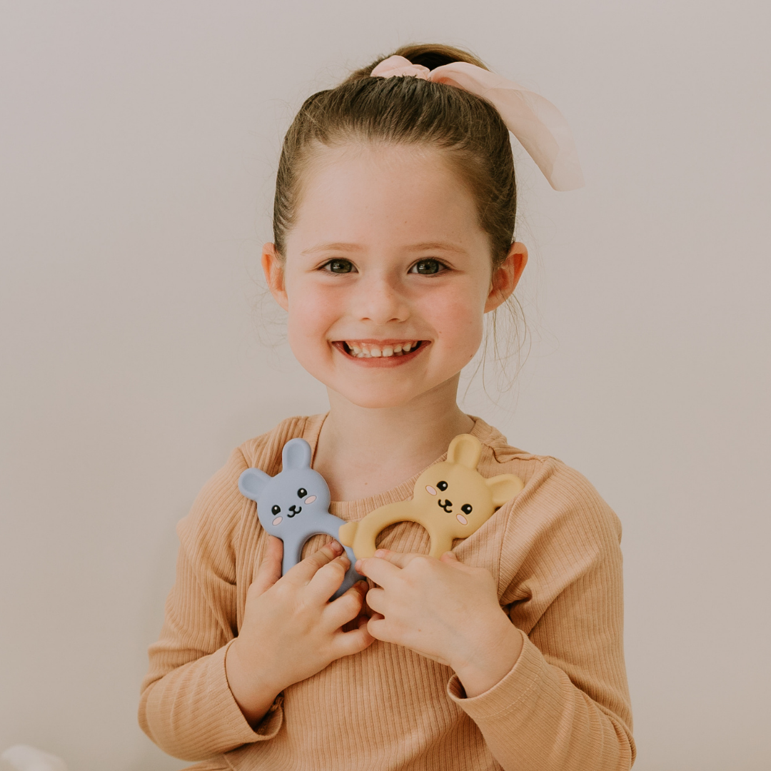 Girl holding bunny teethers