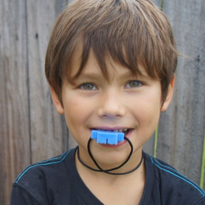 Boy chewing on robot pendant