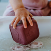 Photo of baby holding a silicone bath toy