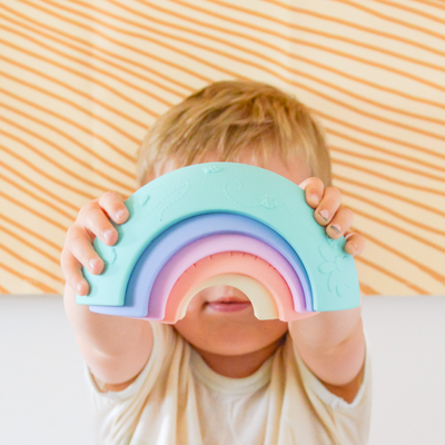 Boy playing with silicone rainbow toy