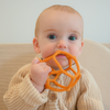 Baby chewing on a sensory ball