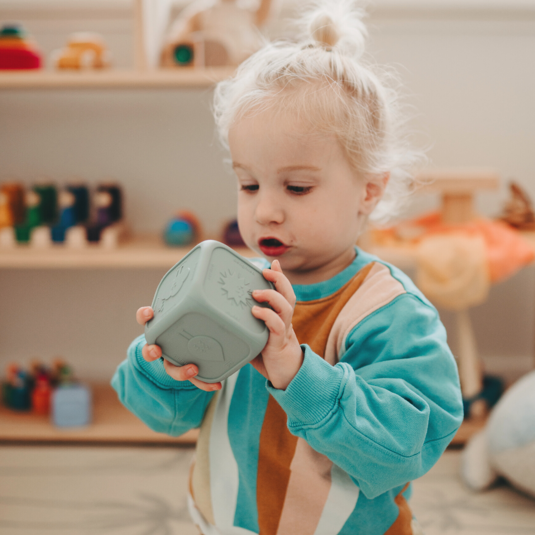 Boy playing with silicone feelings cube