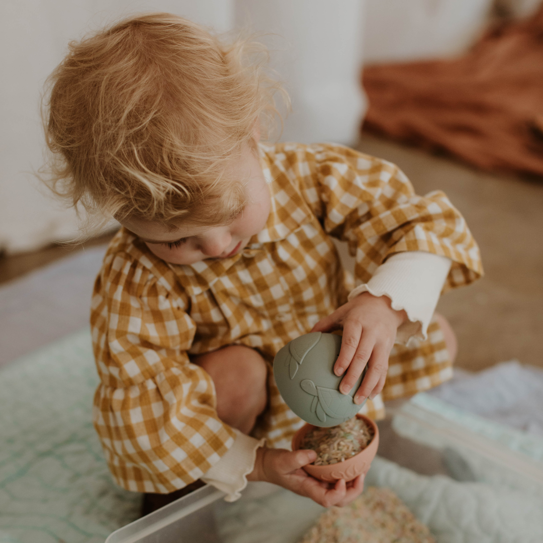 Girl holding rice in a stacking cup