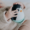 Baby holding penguin wobble toy