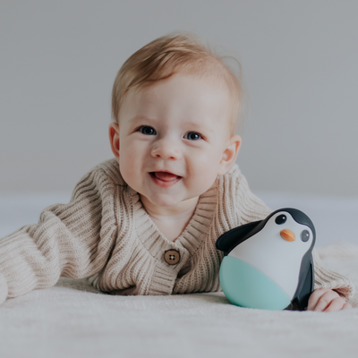 Baby with penguin wobble toy
