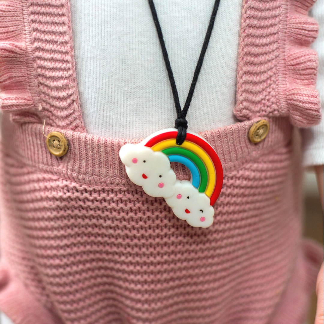 Girl wearing rainbow pendant.