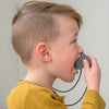 Boy chewing robot pendant