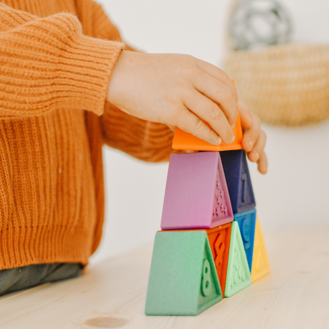 Boy stacking triblox tower